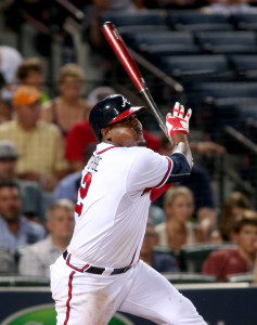 Jul 21, 2015; Atlanta, GA, USA; Atlanta Braves third baseman Juan Uribe (2) singles on a fly ball scoring a run in the fifth inning of their game against the Los Angeles Dodgers at Turner Field. Mandatory Credit: Jason Getz-USA TODAY Sports