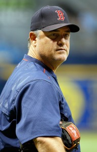 Boston Red Sox pitching coach John Farrell (C) and catcher Jason