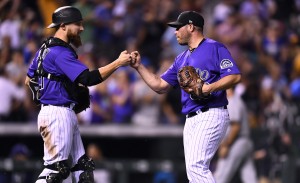 Aug 18, 2017; Denver, CO, USA; Colorado Rockies catcher Jonathan Lucroy (21) and relief pitcher Greg Holland (56) celebrate the win over the at Coors Field. Mandatory Credit: Ron Chenoy-USA TODAY Sports