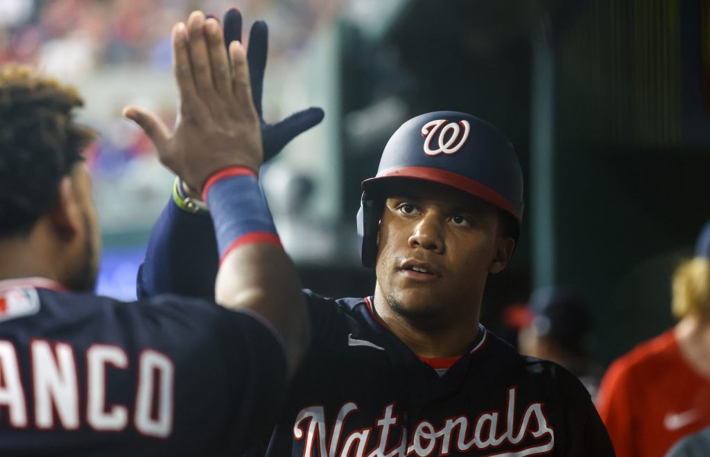 Washington Nationals shortstop CJ Abrams yawns behind his glove